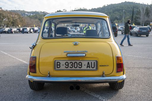 Rear view of a classic yellow Morris Mini Cooper S 1300 with a white roof