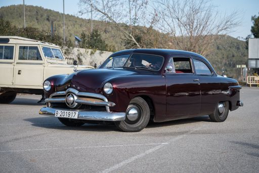 Front view of a beautiful classic American car, the '49 bullet nose Ford in purple