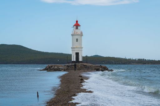The Tokarevsky Lighthouse, situated in the picturesque city of Vladivostok, Russia, stands majestically against a brilliant blue sky
