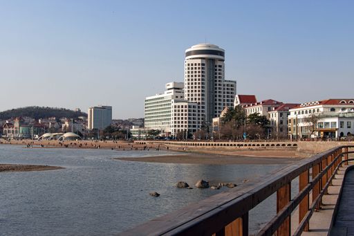 A scenic view of the seaside boardwalk against buildings at Qingdao, China