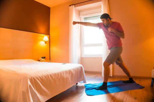 A young male practicing cardio pinches at home during the covid-19 pandemic