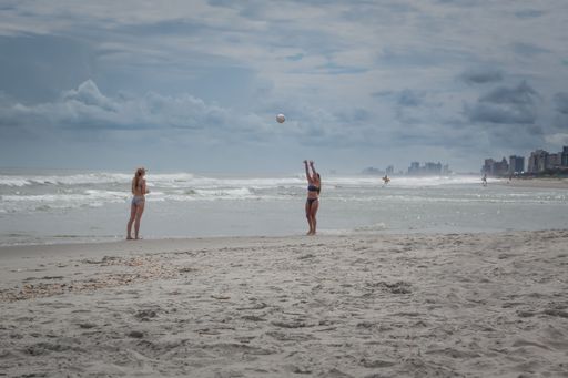 Two attractive young women playing beach volleyball at Myrtle Beach, South Carolina, USA