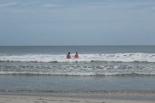 Two people swimming in the beautiful blue ocean of Myrtle Beach, South Carolina