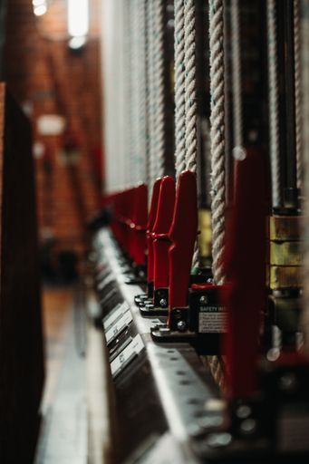 A closeup shot of a row of stage ropes against a blurry background.