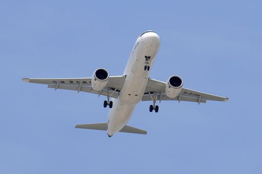 A China Eastern airplane with its landing gear extended soaring through the sky