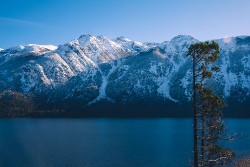 An aerial view of lake surrounded by mountains