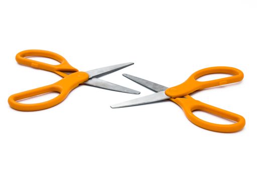 A closeup shot of two orange scissors isolated on a white background