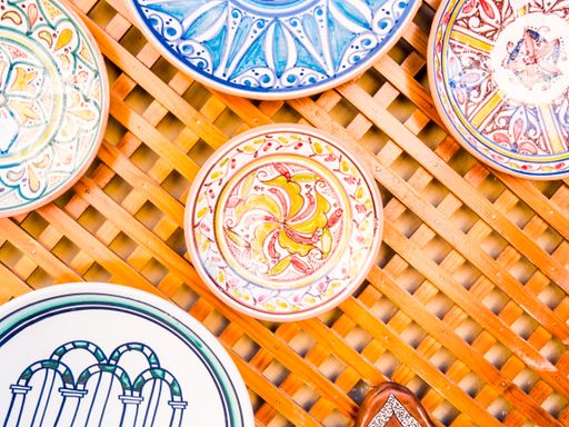A selective focus shot of ceramic Moroccan plates on a wooden wall