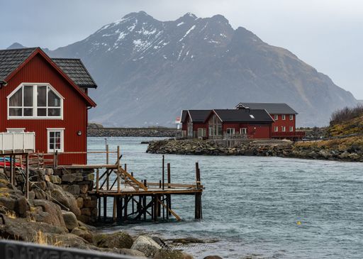 A view of buildings surrounded by mountains and water