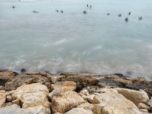 A closeup of stone Breakwater in the beach of Valencia, Spain