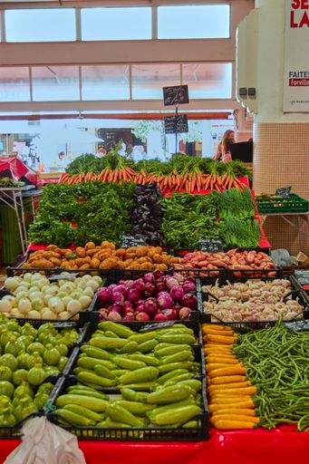 A vertical shot of the bazaar full of different vegetables