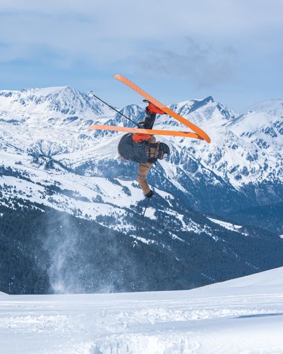 A vertical shot of a young male skiing in the Pyrenees at the Grandvalira ski resort in Andorra