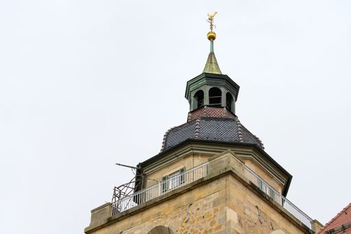 Kirchheim, Germany, March 24 2023: Martinkirche - Protestant town church detail view - top church tower with weathercock and observation platform.