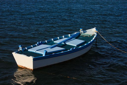 A closeup of a fishing boat on the sea under the sunlight in the daytime