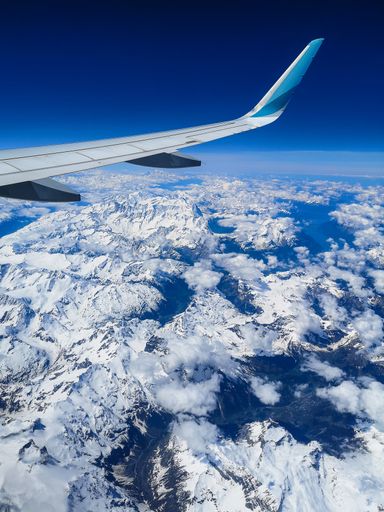 A beautiful shot of snow-covered mountains from the airplane's window