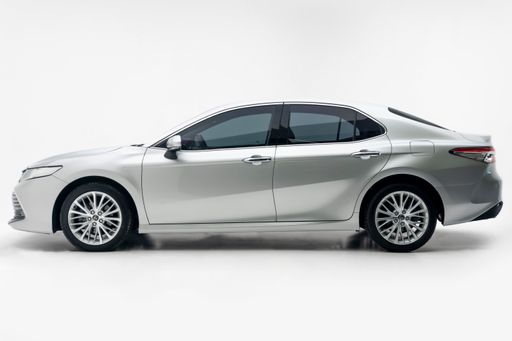 A modern silver sedan car on a white background.