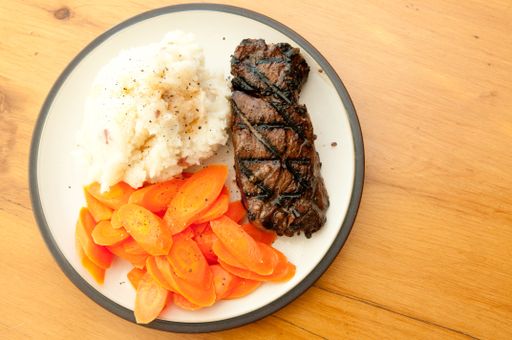 new york strip steak with mashed potatoes and carrots