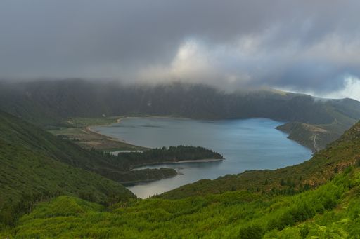 The view of the lake surrounded by mountains in Lagoa do Fogo, Azores, Portugal on a gloomy day