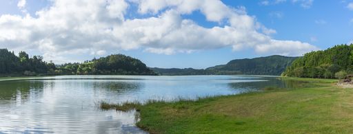 The panorama view of Furnas lake and the mountains under the blue sky in Sao Miguel, Azores, Portugal
