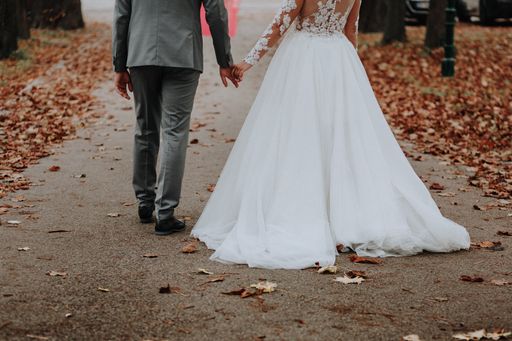 A beautiful view of bride and groom walking into the garden