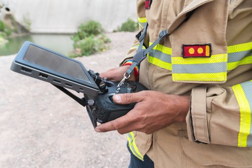 A male firefighter operating a drone for search and rescue