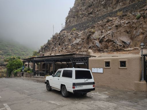 A view of an old white Toyota Hiace van parked outdoors