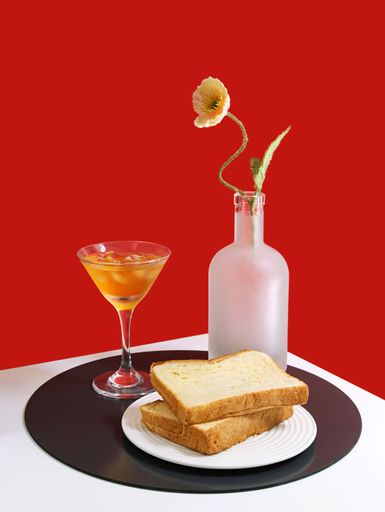 A vertical shot of appetizing snacks acccomponied with drinks isolated on red background