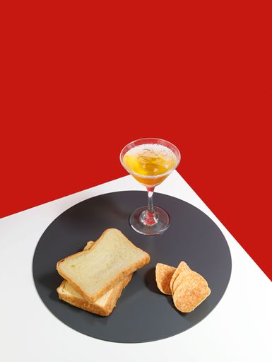 A vertical shot of appetizing snacks accomponied with drinks isolated on red background
