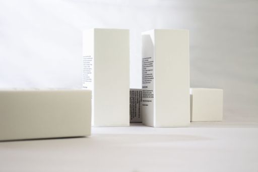 A product shot of four white rectangular boxes with copy space for text and branding