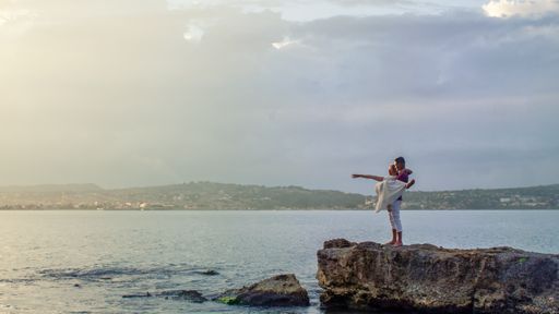 A lovely couple standing on a beach in Cuba