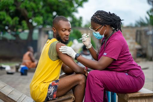 A young African nurse with a patient in a home care service.