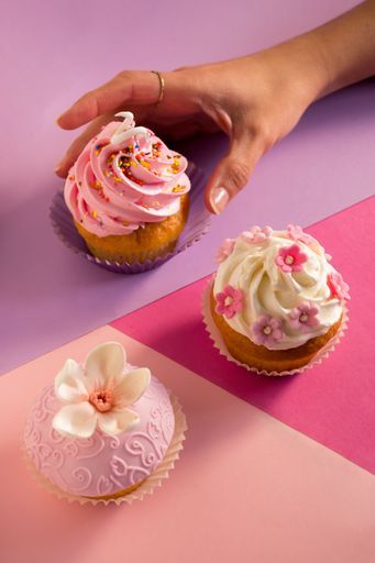 A closeup of cupcakes on purple background