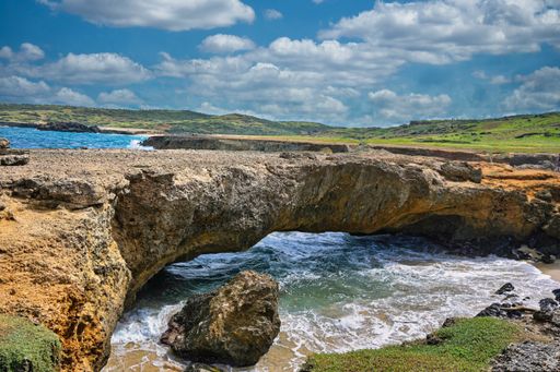 A scenic view of Natural Bridge in Aruba, West Indies on a sunny day