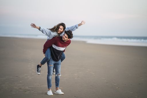 A selective focus shot of a happy Caucasian couple from Spain on the beach