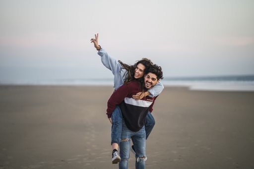 A selective focus shot of a happy Caucasian couple from Spain on the beach