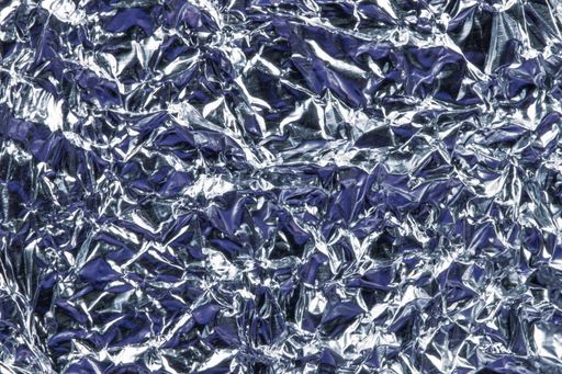 A top view of wrinkled tin foil - metallic wrinkle texture wallpaper