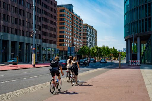 Berlin, Germany - May 8, 2020: Cyclists on a bike path at Potsdamer Platz in downtown Berlin. 