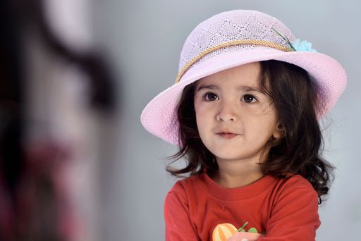 Indian baby girl wearing pink hat, isloated