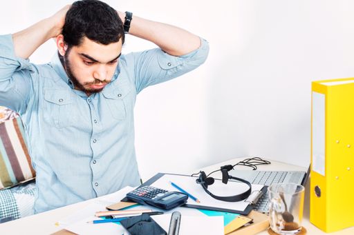 A young Israeli male freelancer stressed, bored, and tired of working