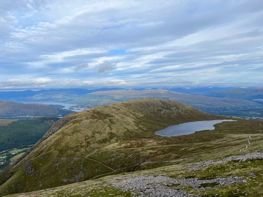 Aerial view of Ben Nevis, the highest mountain in the UK, showcasing its lush green vegetation