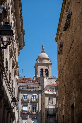 view of a street in the city of Ourense, houses and a tower of the cathedral. Galicia, Spain.