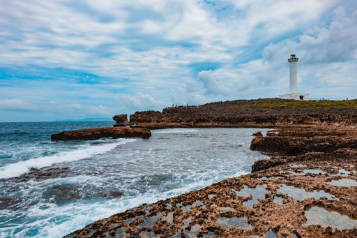 A picturesque view of the Cape Zanpa Lighthouse situated along the rugged coast of Okinawa, Japan