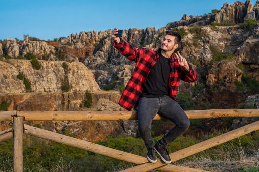 A young Caucasian man taking happy selfies in Sierra Norte Cazalla, Spain
