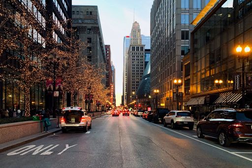 A city street in Chicago, Illinois illuminated by the night lights