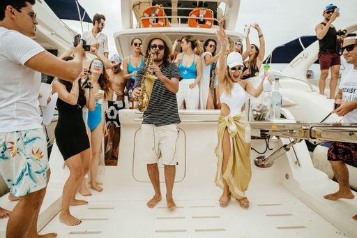 A group of people dancing and having fun on a luxurious yacht