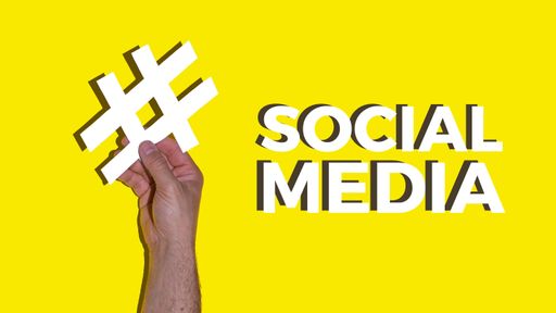 A male hand holding a white hash on a yellow background with Social media text