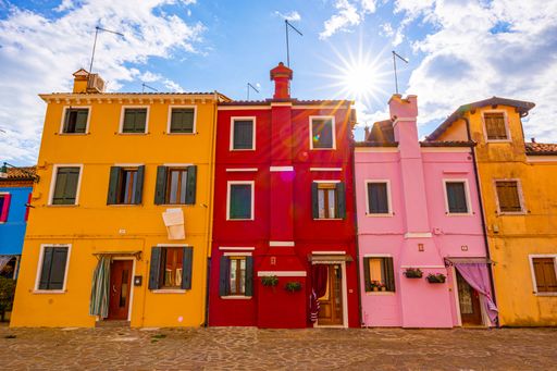 A scenic view of colorful houses on a sunny day in Burano, Italy