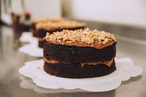 A delicious, freshly-baked cake sits atop a wooden table