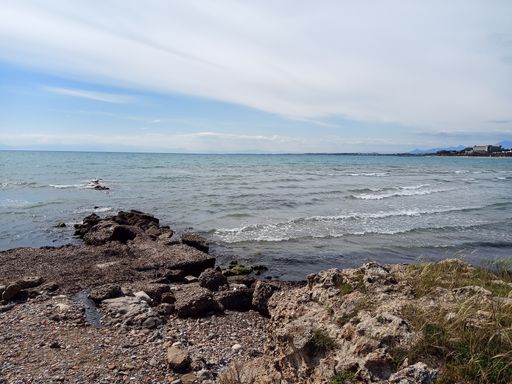 A scenic shot of rocky beach on a bright sky background