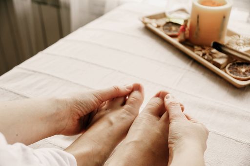 A closeup shot of a female massaging her feet - concept of self-care
